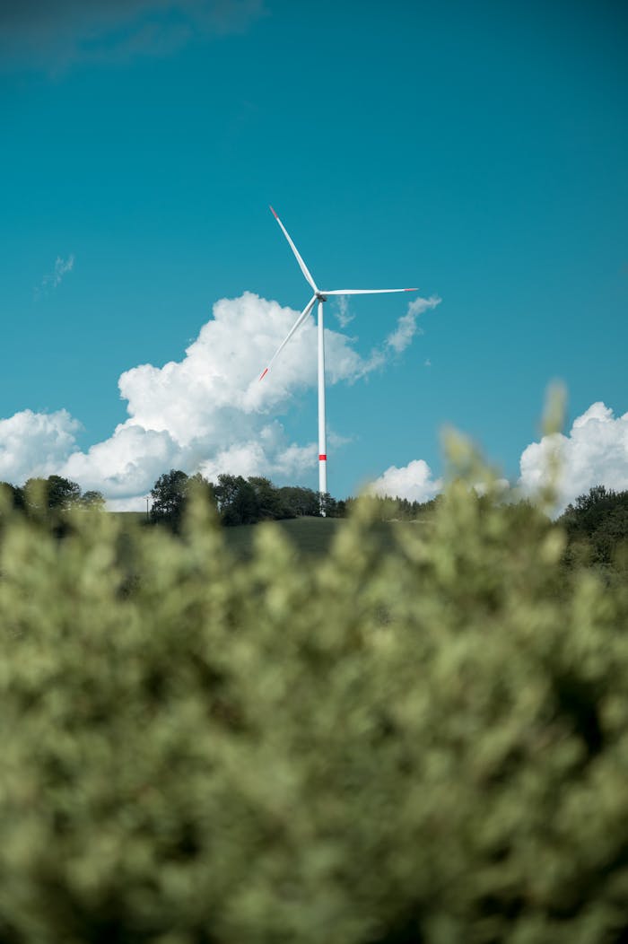 Wind turbine against a blue sky and clouds in Zlatá Olešnice, Czechia.